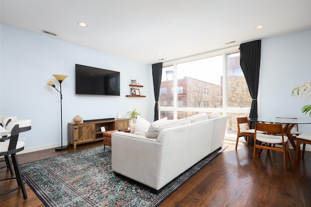 living room featuring dark wood-style floors, recessed lighting, and baseboards