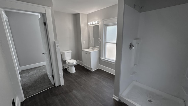 full bathroom featuring a shower stall, vanity, and wood finished floors