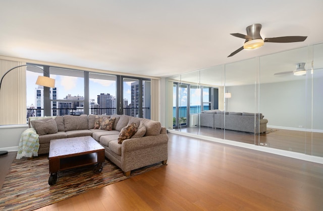 1560 N Sandburg Ter Unit 2506J, Chicago, IL 60610 - living area with wood finished floors, a ceiling fan, baseboards, and a city view