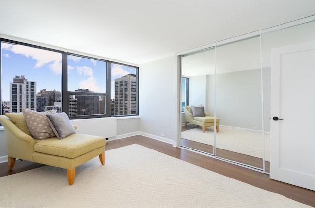 1560 N Sandburg Ter Unit 2506J, Chicago, IL 60610 - sitting room featuring wood finished floors, baseboards, and a view of city