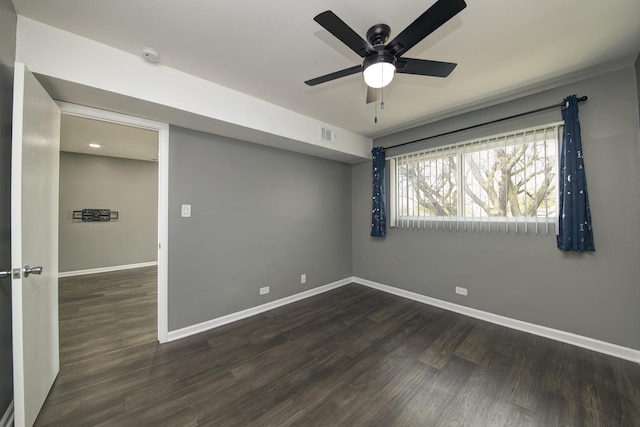 spare room featuring baseboards, ceiling fan, and wood finished floors