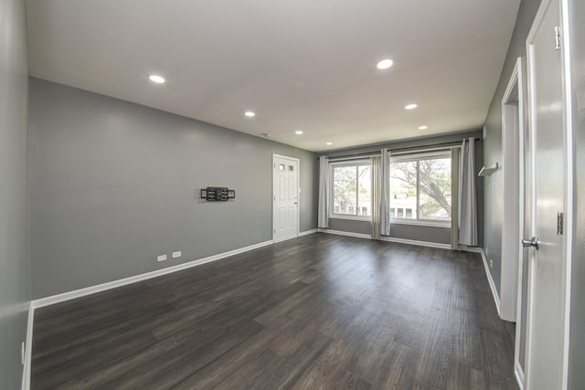 unfurnished room featuring recessed lighting, dark wood-type flooring, and baseboards