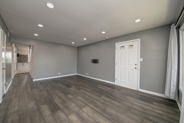 unfurnished room with recessed lighting, dark wood-style floors, and baseboards