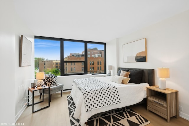 1560 N Sandburg Ter Unit 411J, Chicago, IL 60610 - bedroom with light wood-type flooring and baseboards