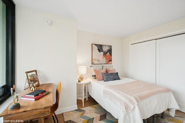 1560 N Sandburg Ter Unit 411J, Chicago, IL 60610 - bedroom with baseboards, a closet, and a desk
