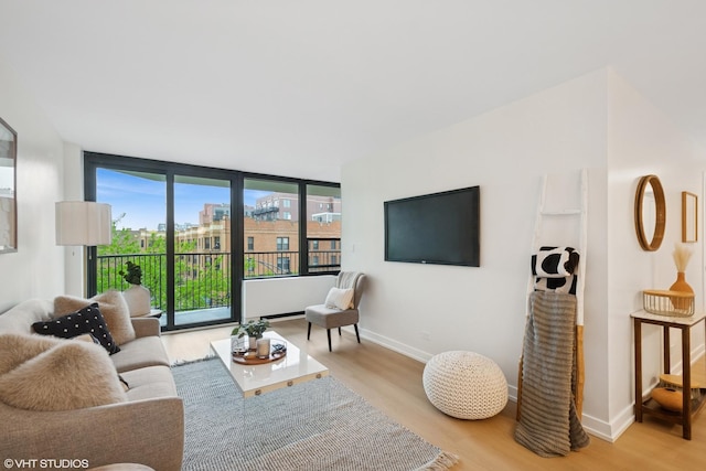 1560 N Sandburg Ter Unit 411J, Chicago, IL 60610 - living room featuring wood finished floors and baseboards
