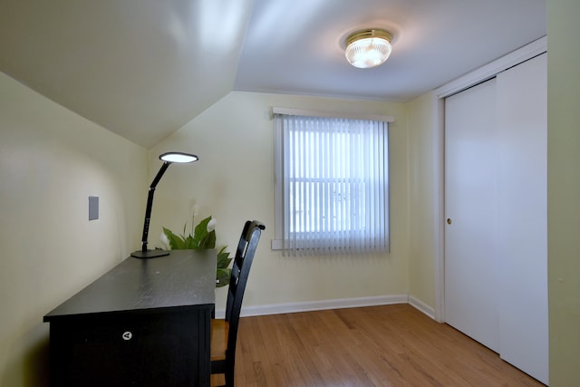 office space with wood finished floors, lofted ceiling, and baseboards