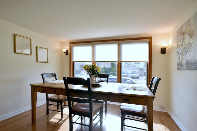 home office featuring plenty of natural light, light wood-type flooring, and baseboards