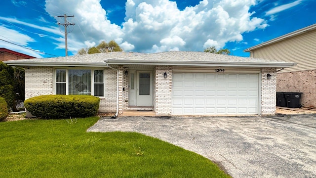single story home featuring asphalt driveway, brick siding, an attached garage, a front yard, and a shingled roof
