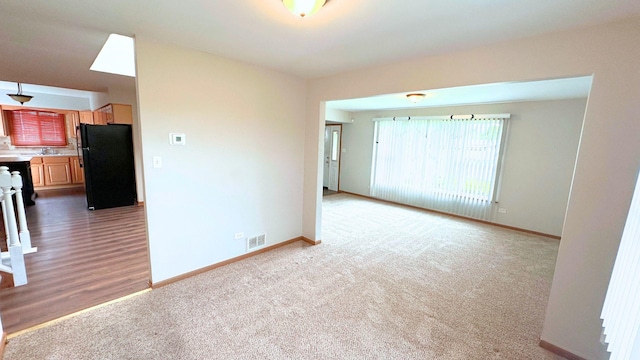 empty room with baseboards and carpet