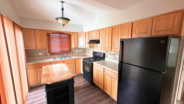 kitchen with black appliances, a sink, under cabinet range hood, light countertops, and lofted ceiling
