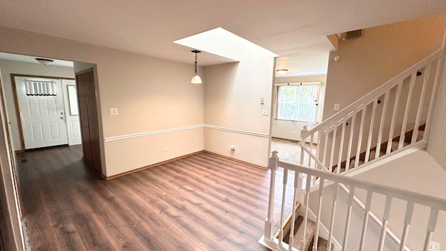 stairway with wood finished floors and baseboards