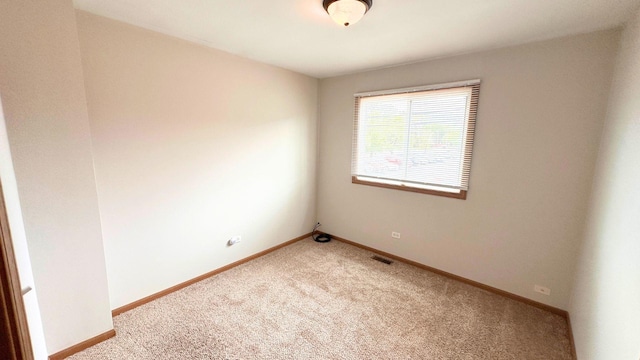 carpeted empty room with baseboards