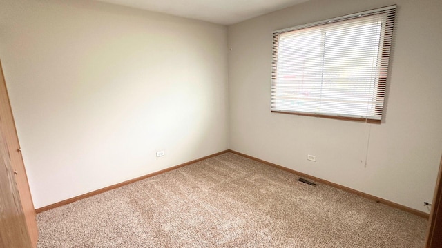 carpeted empty room with baseboards