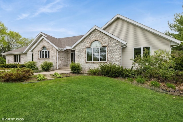 296 Regina Ln, Belvidere, IL 61008 - view of front of house with brick siding, a front lawn, and a shingled roof
