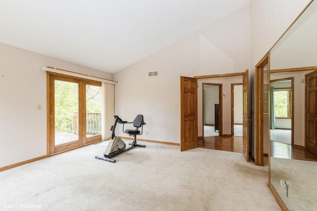 296 Regina Ln, Belvidere, IL 61008 - exercise room with light colored carpet, baseboards, high vaulted ceiling, and french doors