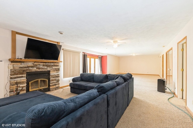296 Regina Ln, Belvidere, IL 61008 - living area with carpet floors, a stone fireplace, ceiling fan, and baseboards