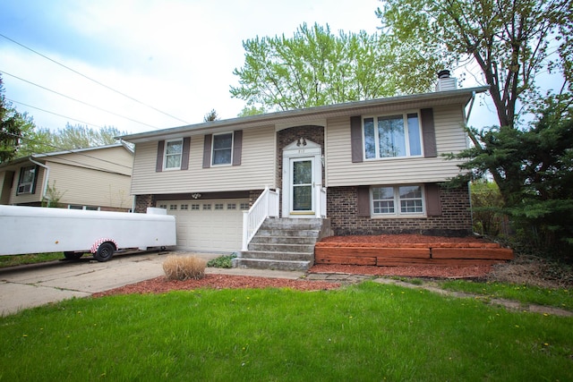 bi-level home with a chimney, concrete driveway, brick siding, a garage, and a front lawn
