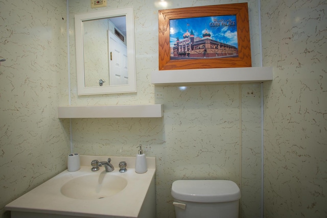 bathroom featuring toilet and vanity