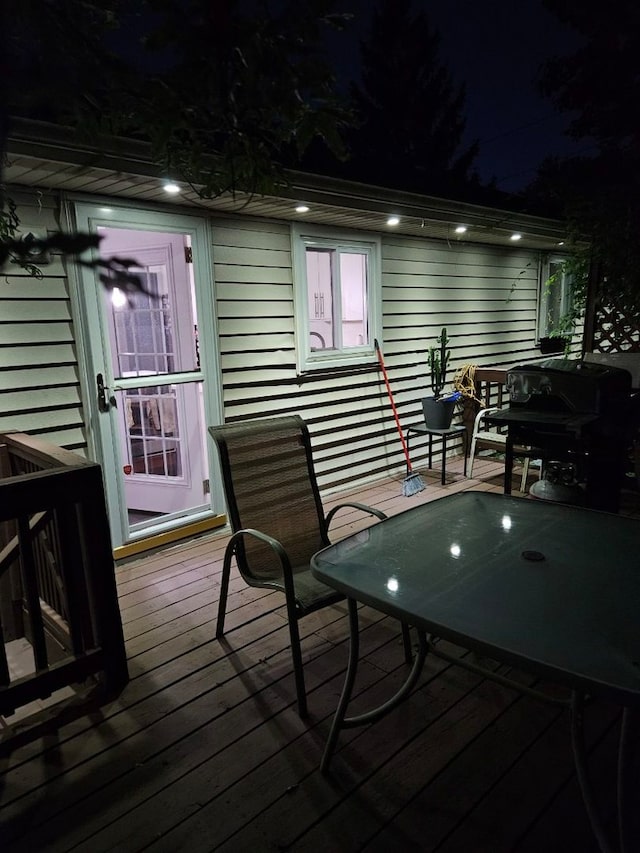 deck at twilight featuring area for grilling