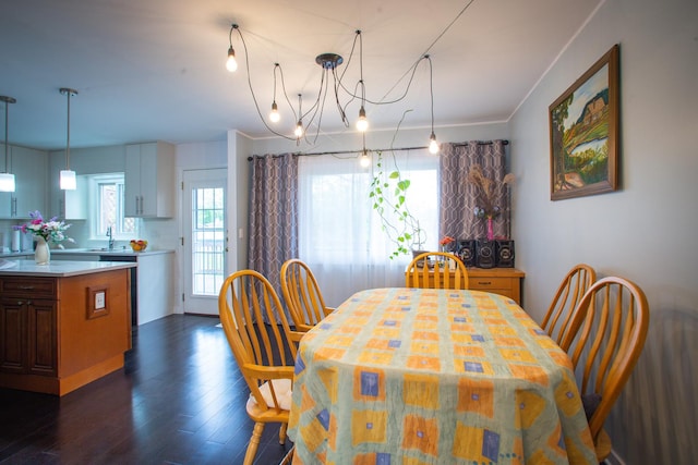 dining area featuring dark wood finished floors and a chandelier