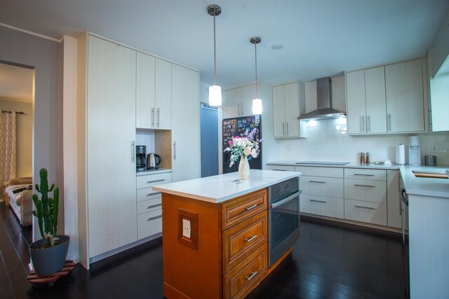 kitchen with wall chimney exhaust hood, stainless steel oven, dark wood-style floors, backsplash, and black electric stovetop