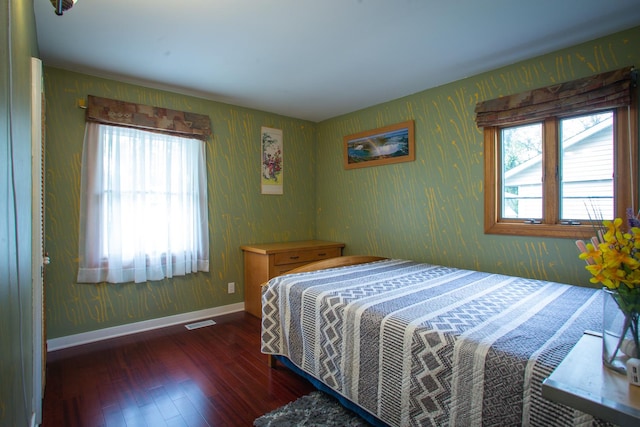 bedroom with wood-type flooring, wallpapered walls, and baseboards