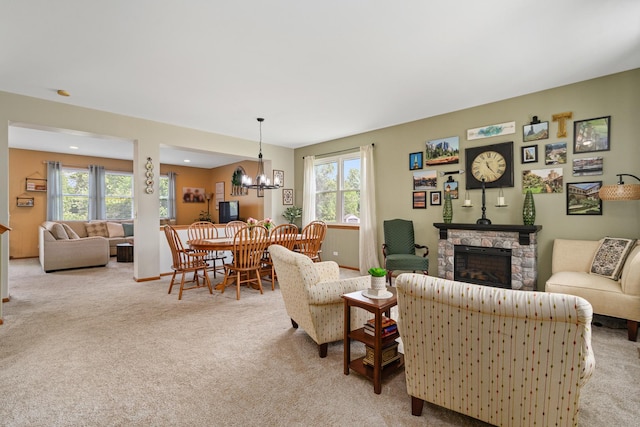 24210 Apple Creek Ln, Plainfield, IL 60586 - living area featuring light colored carpet, a chandelier, and a stone fireplace