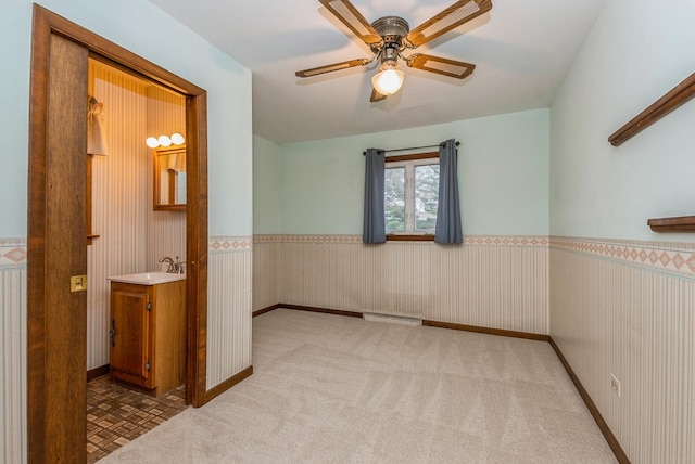10756 Mason Ave, Chicago Ridge, IL 60415 - carpeted spare room featuring a ceiling fan, a sink, a wainscoted wall, visible vents, and baseboards