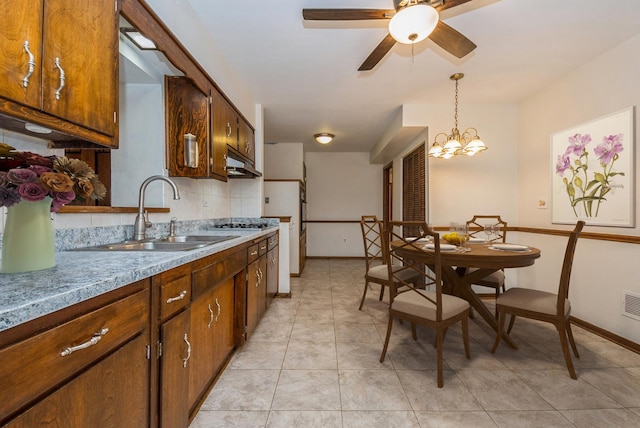 10756 Mason Ave, Chicago Ridge, IL 60415 - kitchen featuring pendant lighting, under cabinet range hood, baseboards, a sink, and ceiling fan with notable chandelier