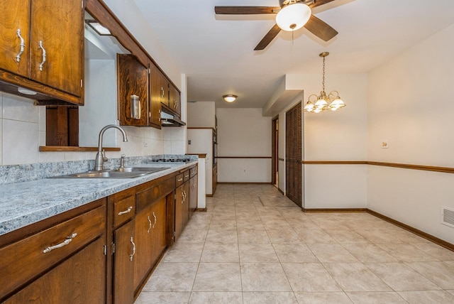 10756 Mason Ave, Chicago Ridge, IL 60415 - kitchen featuring baseboards, under cabinet range hood, a sink, and ceiling fan with notable chandelier