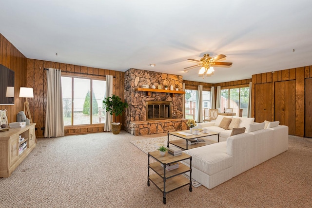 10756 Mason Ave, Chicago Ridge, IL 60415 - living room featuring wood walls, a ceiling fan, a stone fireplace, and light carpet