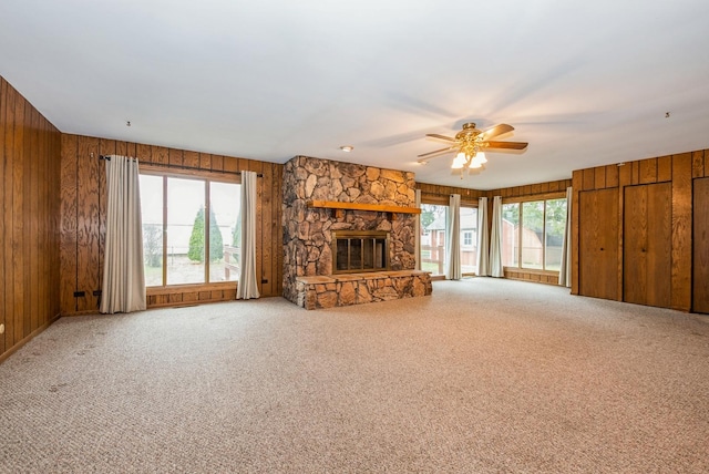 10756 Mason Ave, Chicago Ridge, IL 60415 - unfurnished living room featuring a fireplace, wood walls, carpet, and a ceiling fan