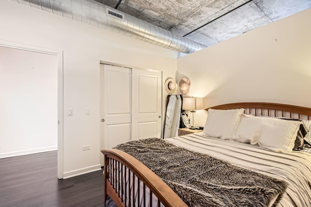 50 E 16th St Unit 1111, Chicago, IL 60616 - bedroom featuring a closet, dark wood finished floors, and baseboards