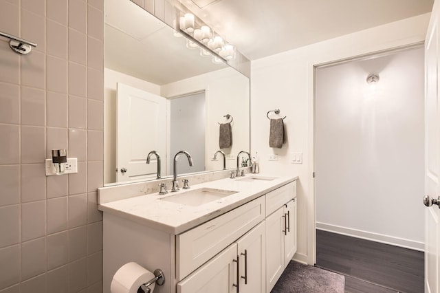 50 E 16th St Unit 1111, Chicago, IL 60616 - full bathroom with double vanity, wood finished floors, and baseboards