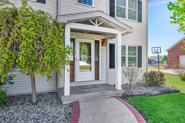 entrance to property with a lawn
