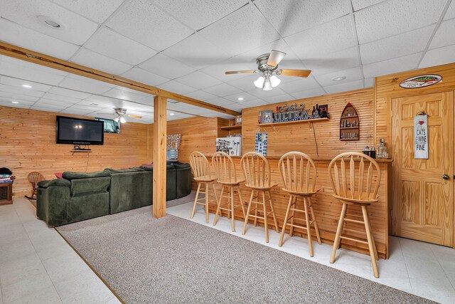 indoor dry bar with wooden walls, a drop ceiling, a ceiling fan, and recessed lighting