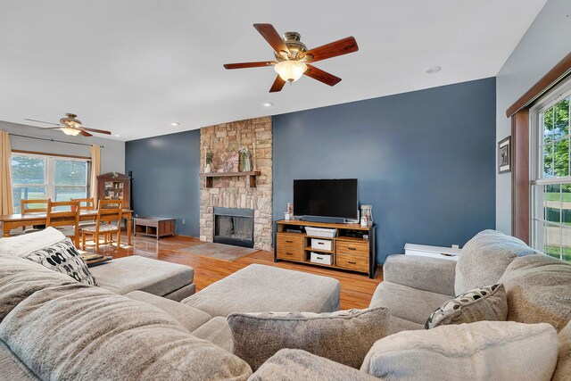 living area featuring a ceiling fan, wood finished floors, a fireplace, and recessed lighting