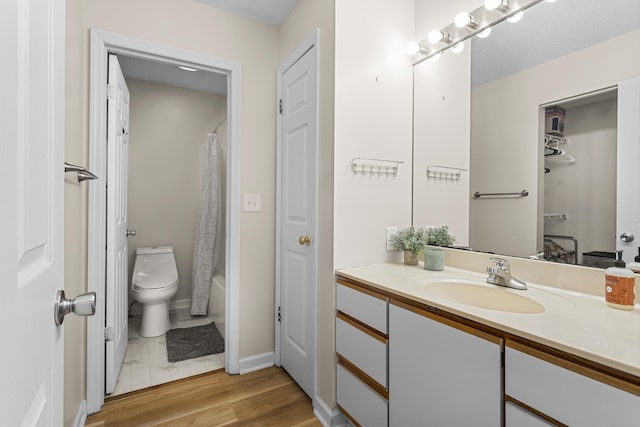 913 W Eads St, Urbana, IL 61801 - bathroom with vanity, toilet, and wood finished floors
