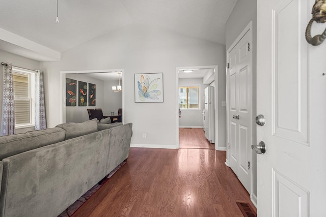 913 W Eads St, Urbana, IL 61801 - living area with dark wood finished floors, lofted ceiling, and baseboards