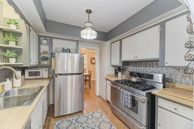 1607 Burlington Ave, Lisle, IL 60532 - kitchen featuring appliances with stainless steel finishes, a sink, backsplash, and light wood-style floors