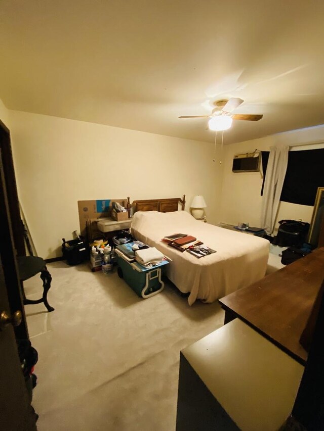 bedroom with carpet, a ceiling fan, and a wall mounted air conditioner