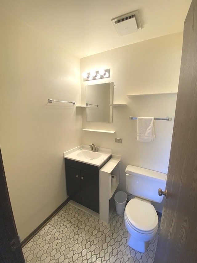 14643 Lamon Ave Unit 2A, Midlothian, IL 60445 - bathroom featuring vanity, toilet, tile patterned floors, and baseboards