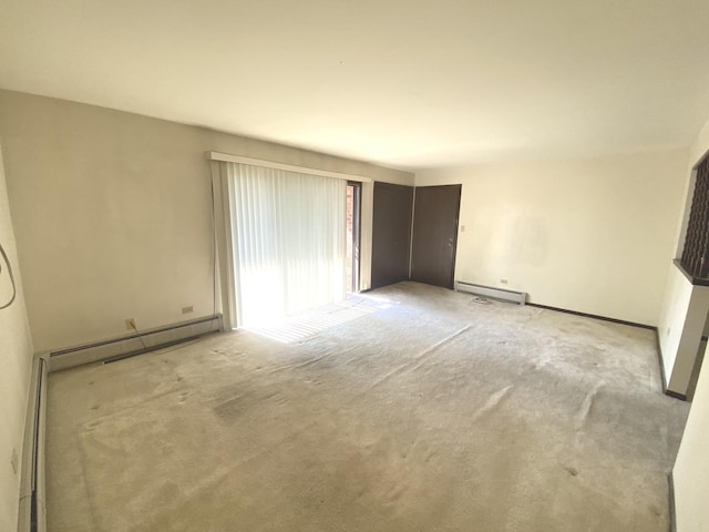 14643 Lamon Ave Unit 2A, Midlothian, IL 60445 - empty room with a baseboard heating unit, carpet flooring, and baseboards