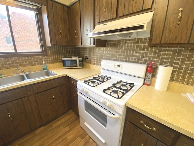14643 Lamon Ave Unit 2A, Midlothian, IL 60445 - kitchen with gas range gas stove, under cabinet range hood, stainless steel microwave, light countertops, and a sink