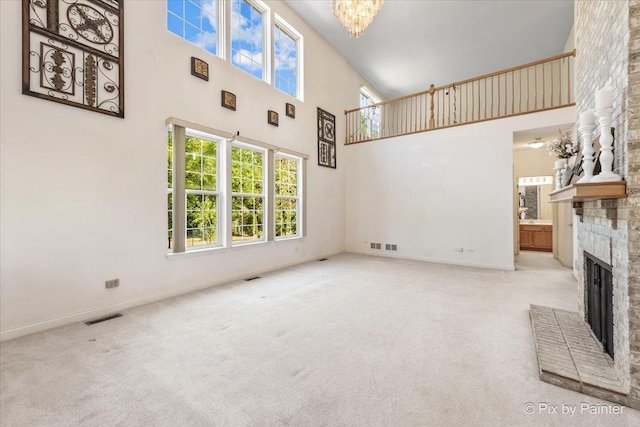 405 Lela Ln, Bartlett, IL 60103 - unfurnished living room with a high ceiling, a fireplace, healthy amount of natural light, carpet, and baseboards