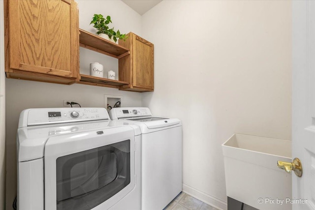 405 Lela Ln, Bartlett, IL 60103 - laundry room featuring cabinet space, washing machine and clothes dryer, and light tile patterned floors