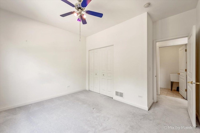 405 Lela Ln, Bartlett, IL 60103 - unfurnished bedroom with light carpet, baseboards, a closet, and ceiling fan