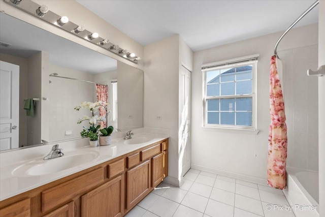 405 Lela Ln, Bartlett, IL 60103 - bathroom with double vanity, shower / bath combo with shower curtain, tile patterned flooring, and baseboards