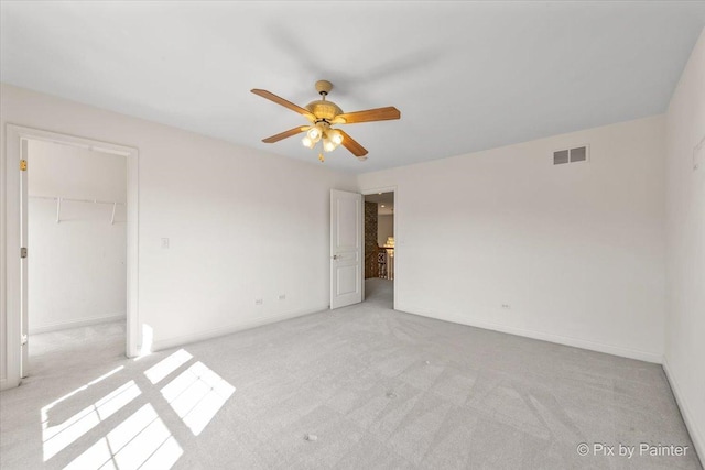405 Lela Ln, Bartlett, IL 60103 - unfurnished bedroom featuring light carpet, a spacious closet, baseboards, and a closet